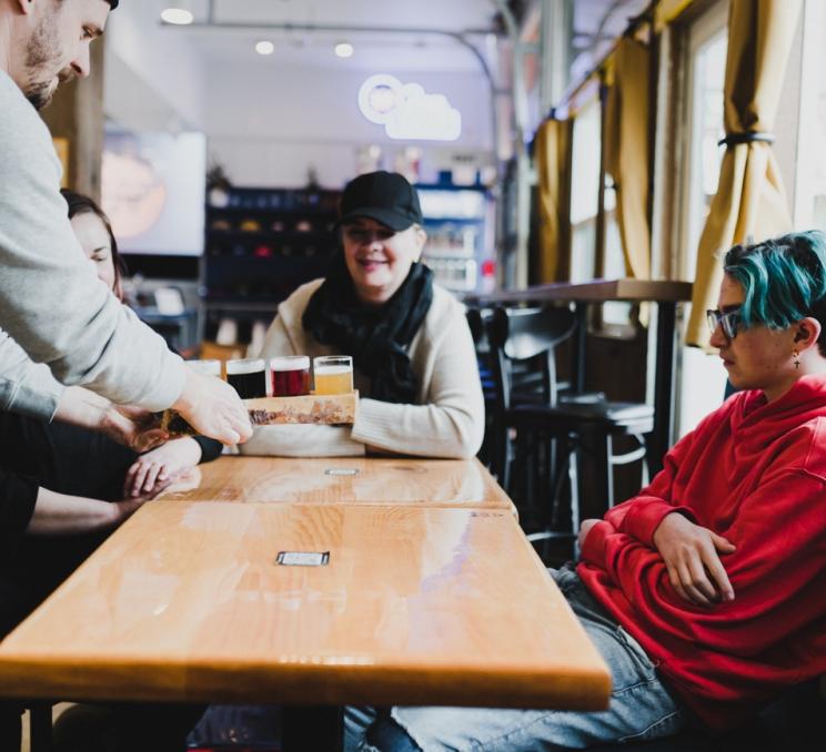 A group dining at Whistle Buoy Brewing in Victoria, BC