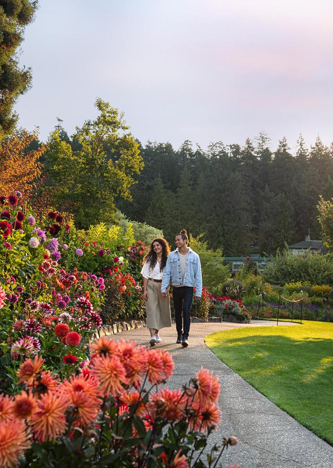 A couple takes a stroll through the Butchart Gardens in Victoria, BC