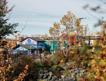 A view through the trees towards Fisherman's Wharf in Victoria, BC