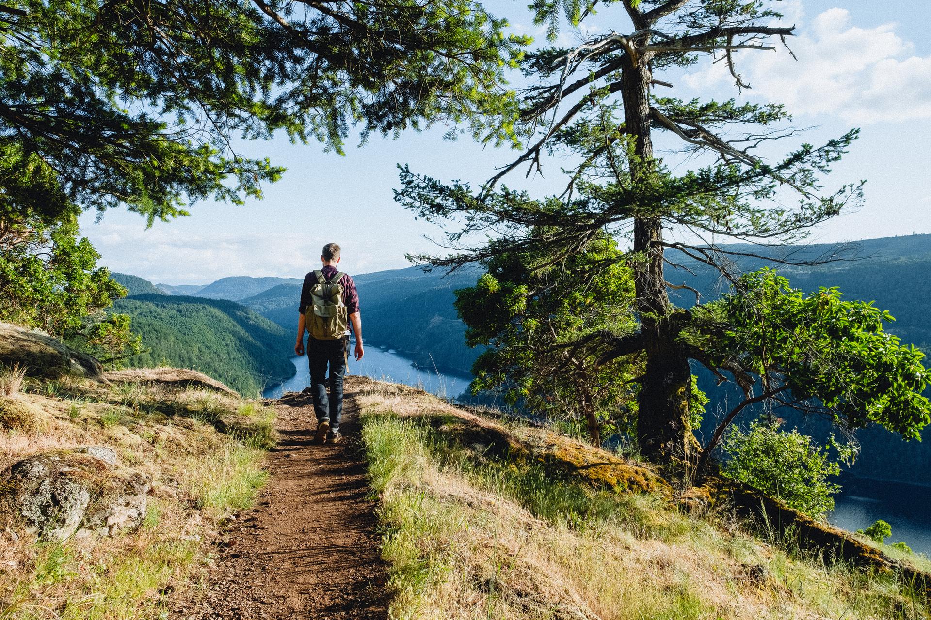 A man walks a trail in Gowlland Tod Provincial Park in Victoria, BC