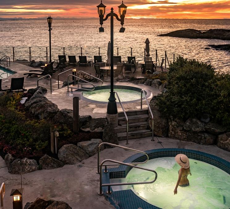 A woman soaks in the spa pool at the Oak Bay Beach Hotel